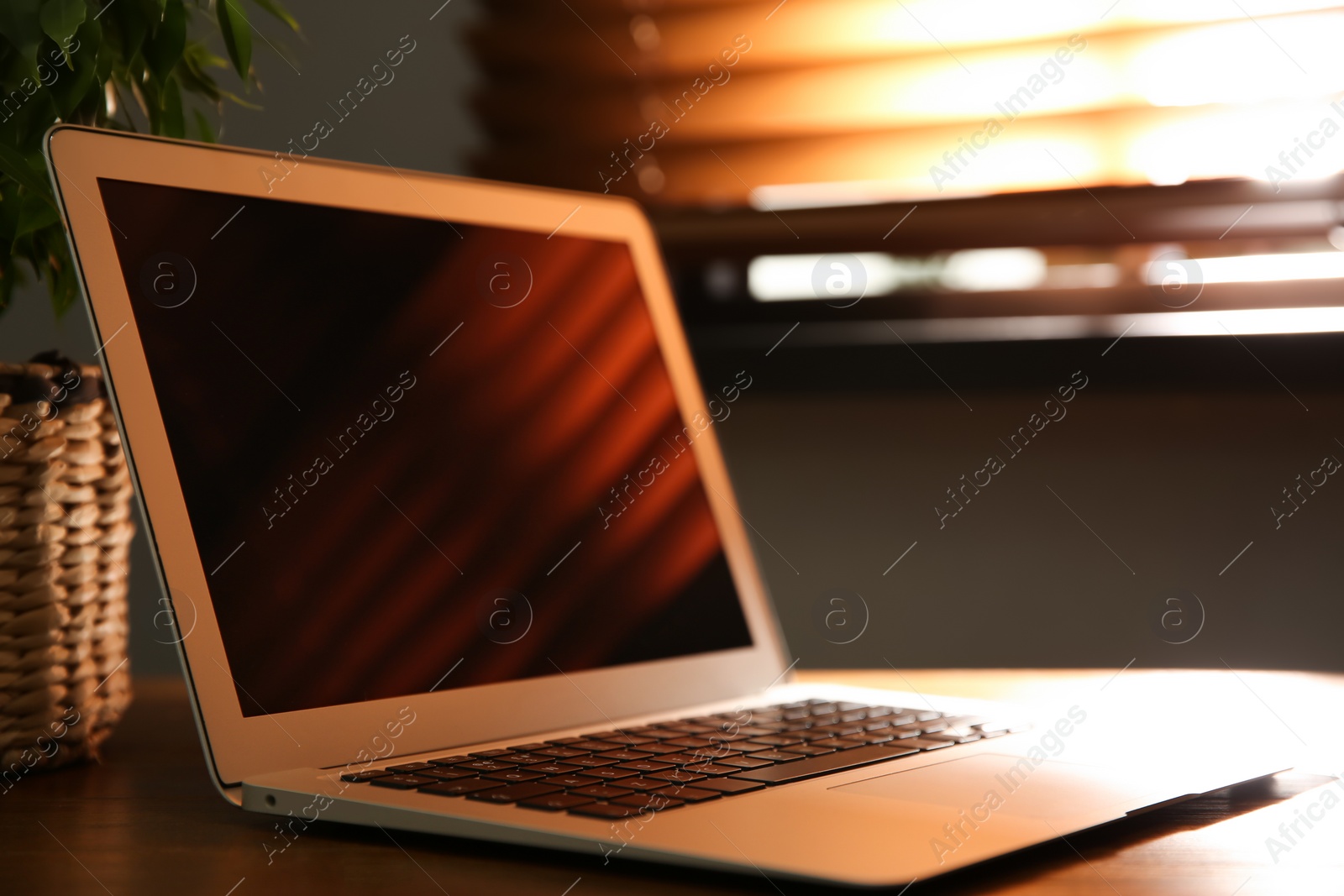 Photo of Modern laptop on wooden table indoors. Space for design