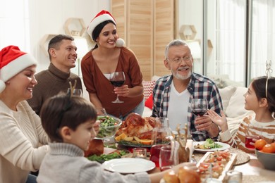 Photo of Happy family enjoying festive dinner at home. Christmas celebration