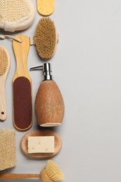 Bath accessories. Flat lay composition with personal care tools on light grey background, space for text
