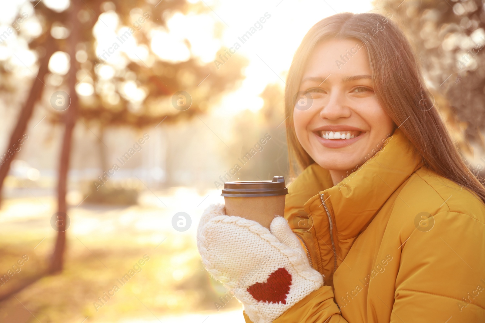 Photo of Young woman with cup of coffee in morning outdoors