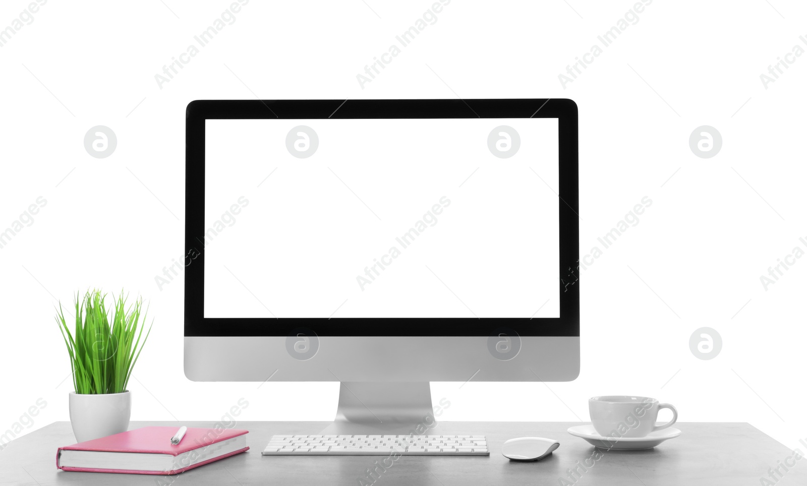 Photo of Computer, potted plant and cup of tea on table against white background. Stylish workplace