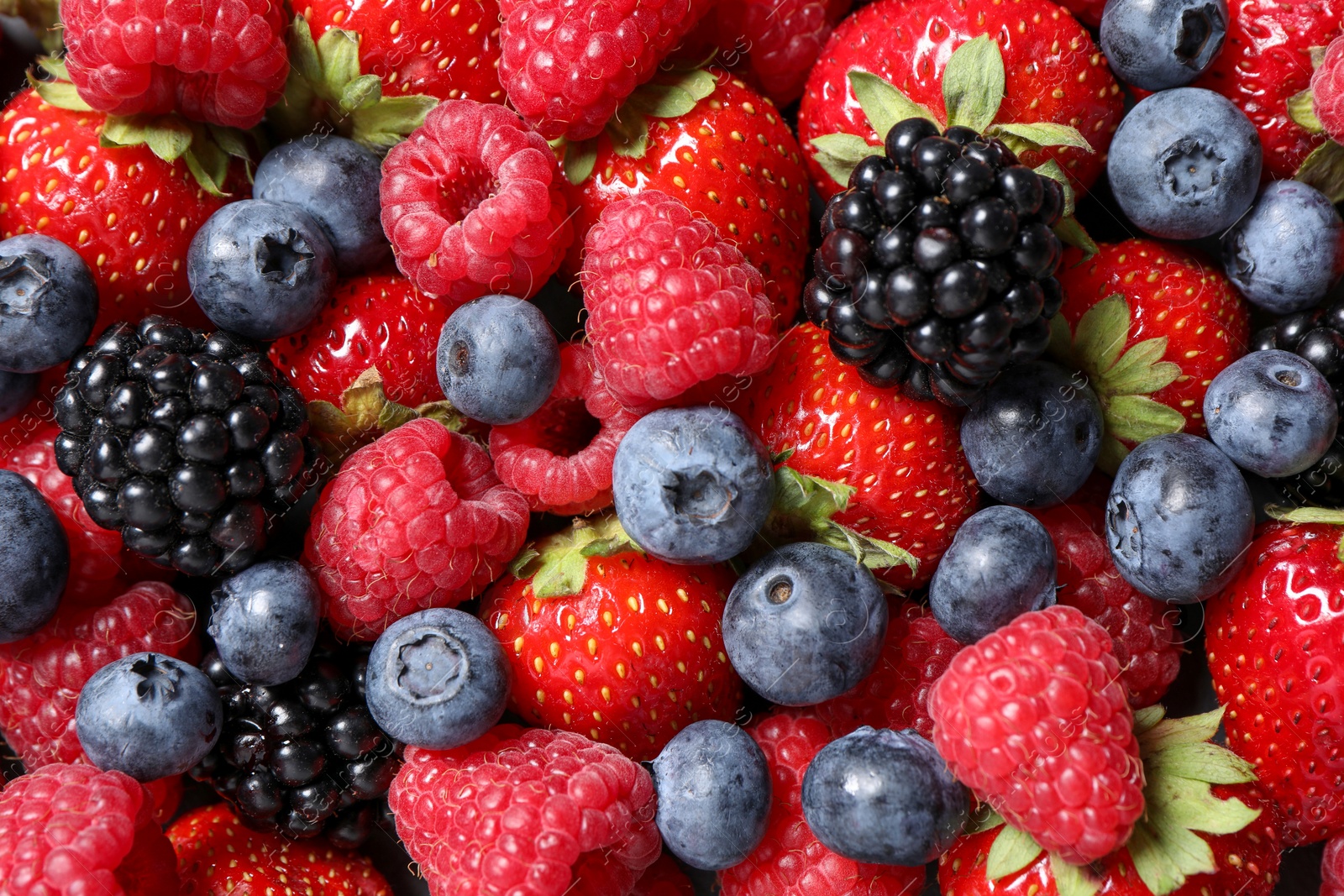 Photo of Assortment of fresh ripe berries as background, top view