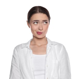 Photo of Embarrassed young woman in shirt on white background