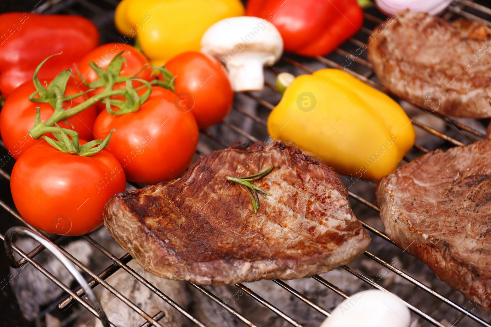 Photo of Modern grill with meat and vegetables outdoors, closeup