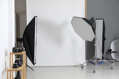 Photo of White photo background and professional lighting equipment in studio