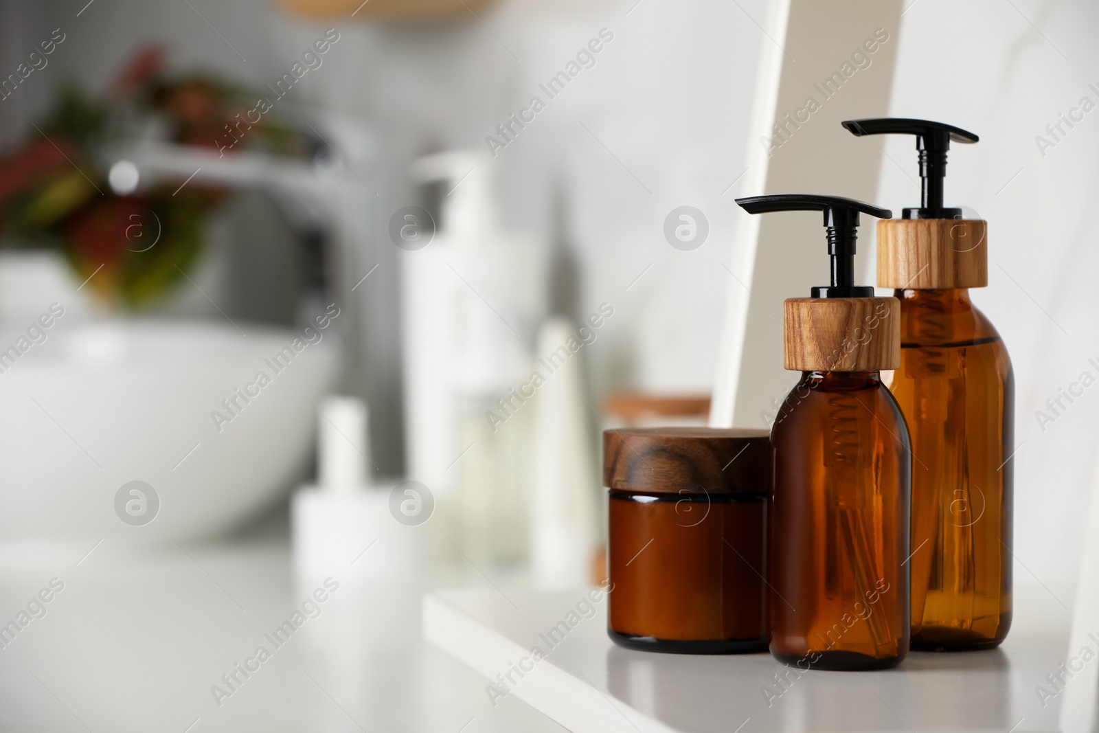 Photo of Different personal care products on shelf in bathroom. Space for text