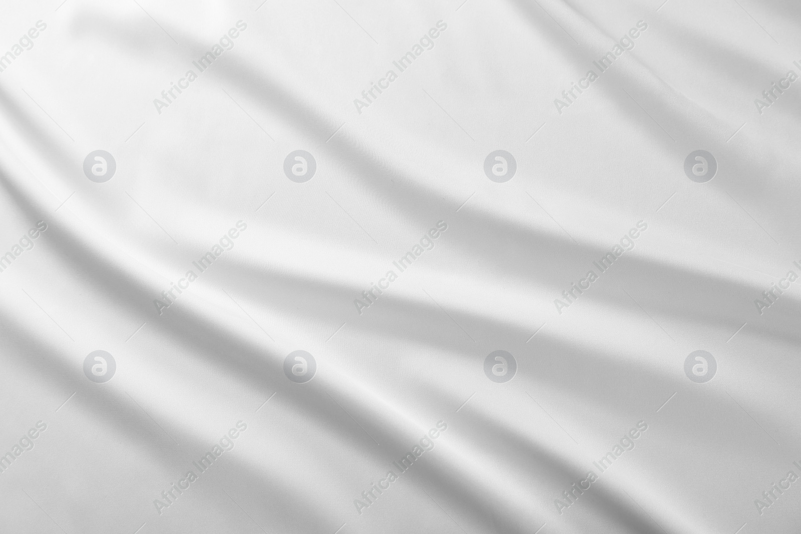 Photo of Texture of white silk ripple fabric as background, top view