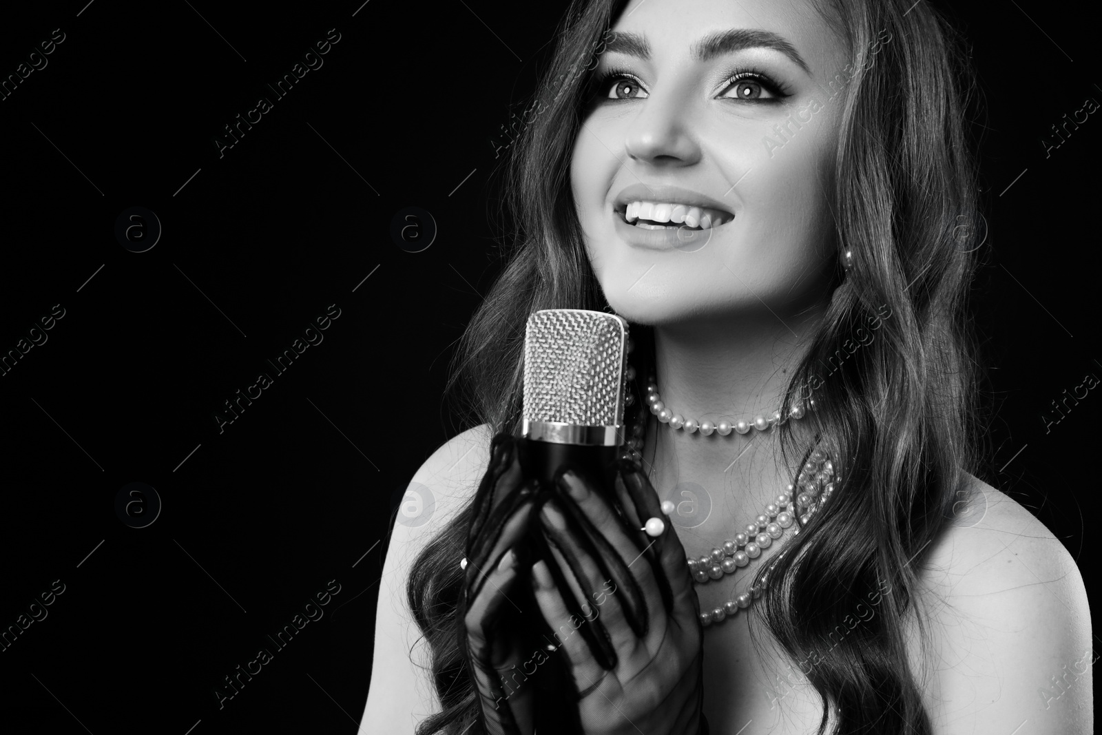 Image of Beautiful singer with microphone, black and white effect