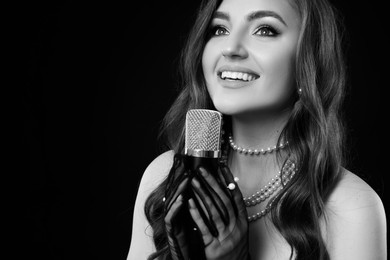Beautiful singer with microphone, black and white effect