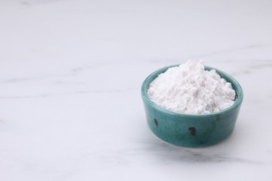 Photo of Bowl of natural starch on white marble table. Space for text