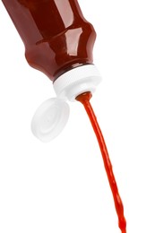 Pouring tasty red ketchup from bottle isolated on white