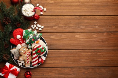 Photo of Delicious homemade Christmas cookies, cocoa and festive decor on wooden table, flat lay. Space for text
