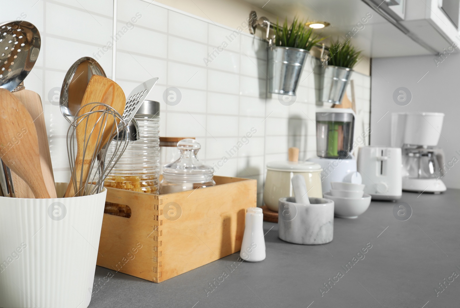 Photo of Different utensils and clean dishes on kitchen counter