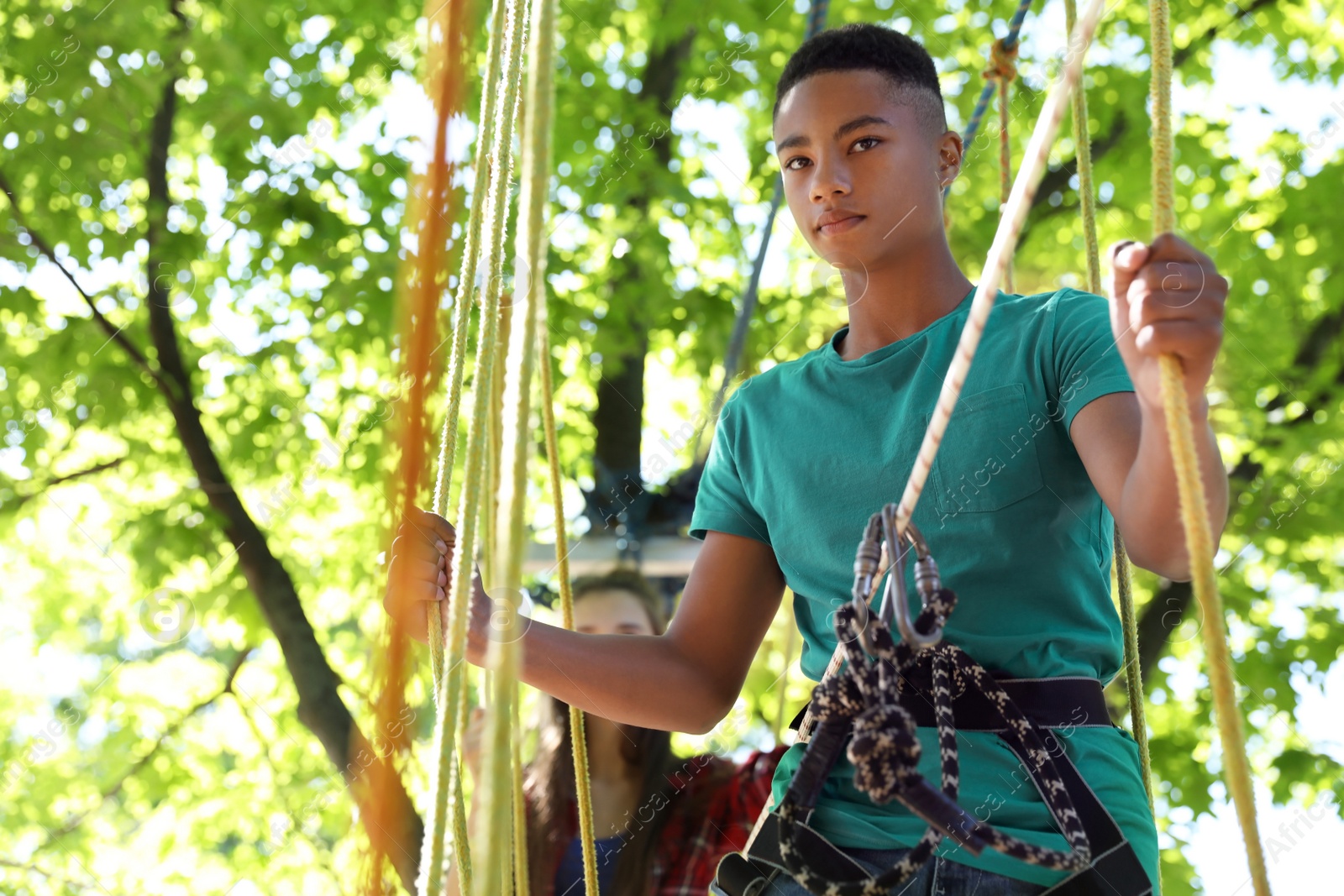 Photo of Children climbing in adventure park. Summer camp