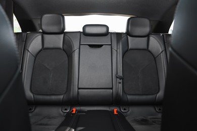 Clean leather seats inside of modern black car