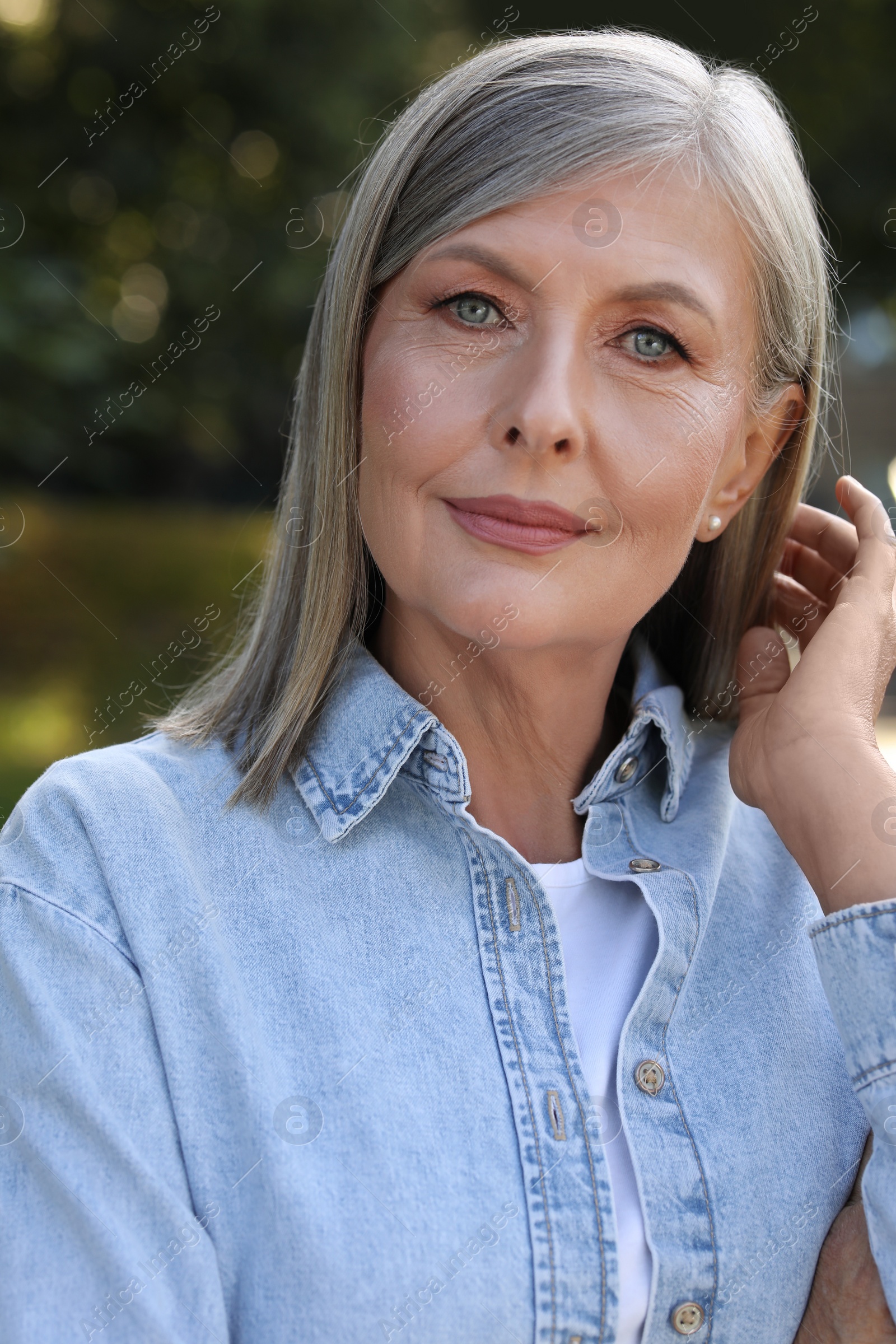 Photo of Portrait of beautiful smiling senior woman outdoors