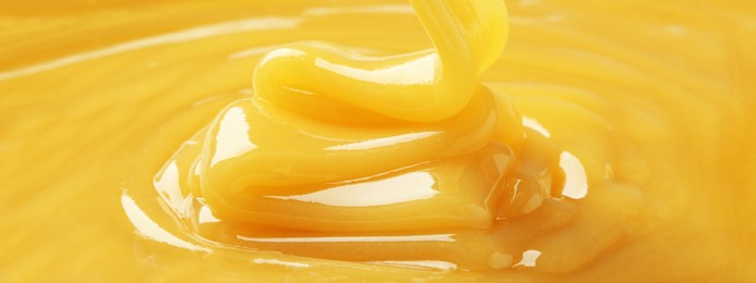 Image of Closeup view of tasty honey as background. Banner design