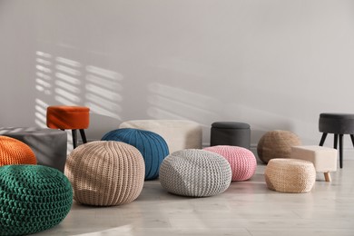 Photo of Many stylish different poufs indoors. Home design