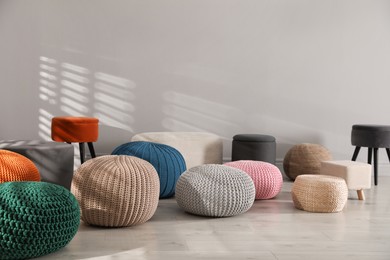 Many stylish different poufs indoors. Home design