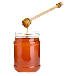 Glass jar of wildflower honey and wooden dipper isolated on white