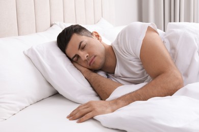 Photo of Handsome man sleeping in bed at home