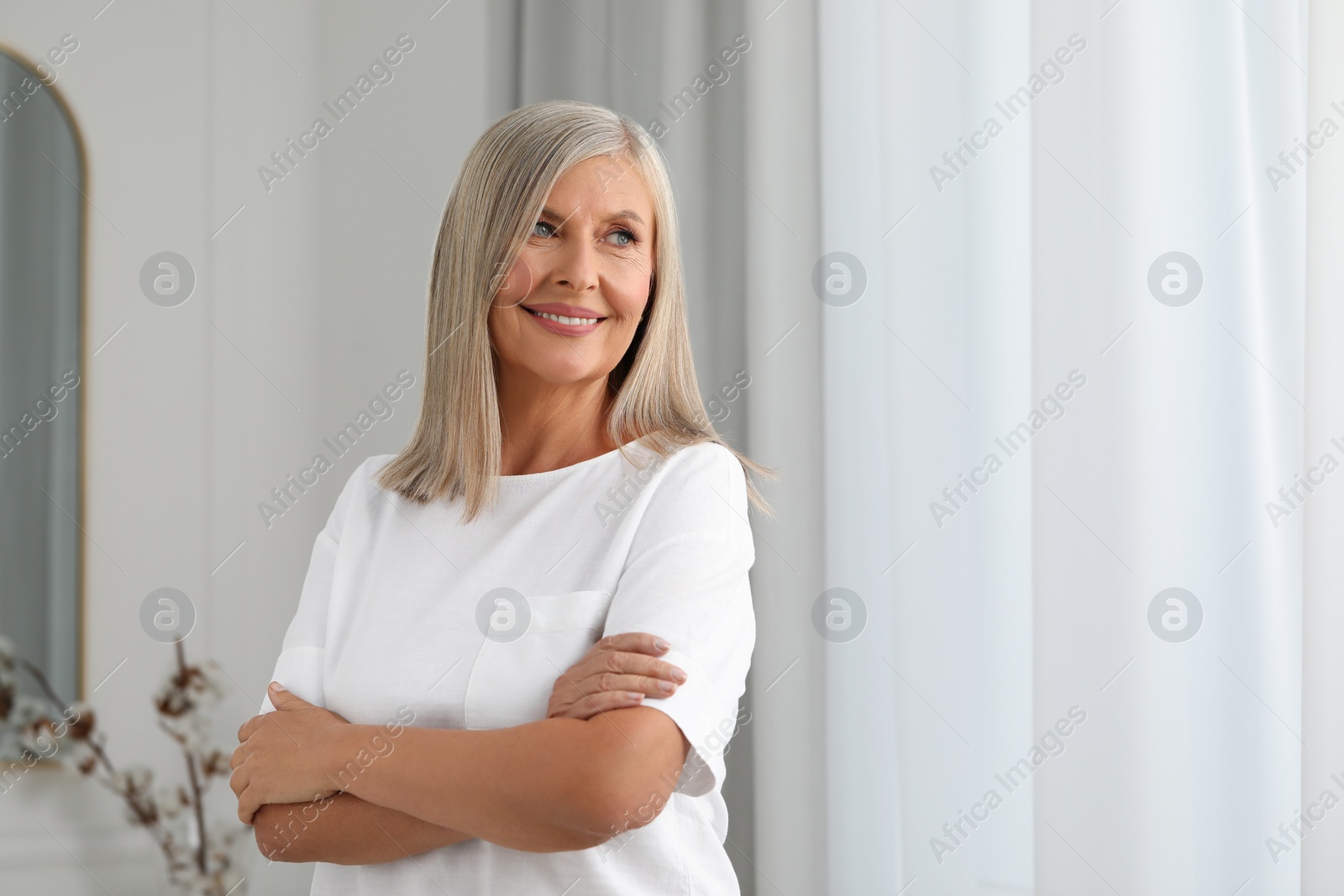 Photo of Portrait of beautiful middle aged woman at home, space for text