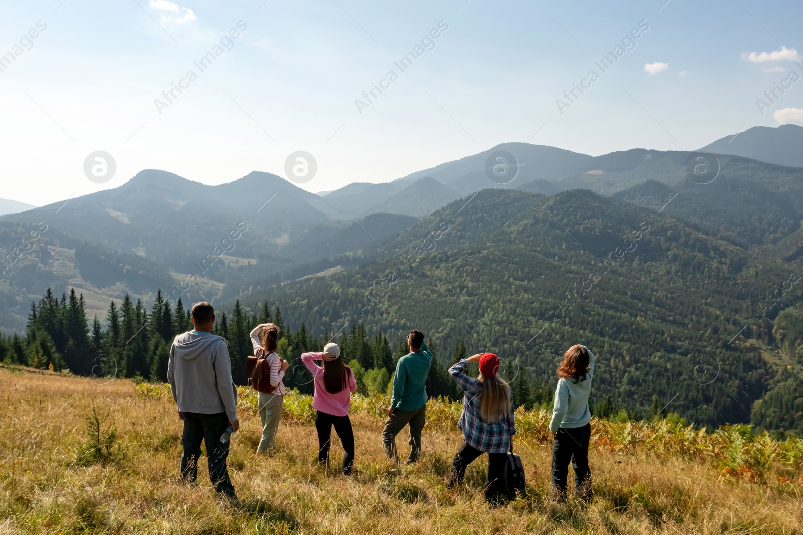 Image of Group of tourists on hill in mountains. Drone photography