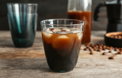 Glass with cold brew coffee on wooden table