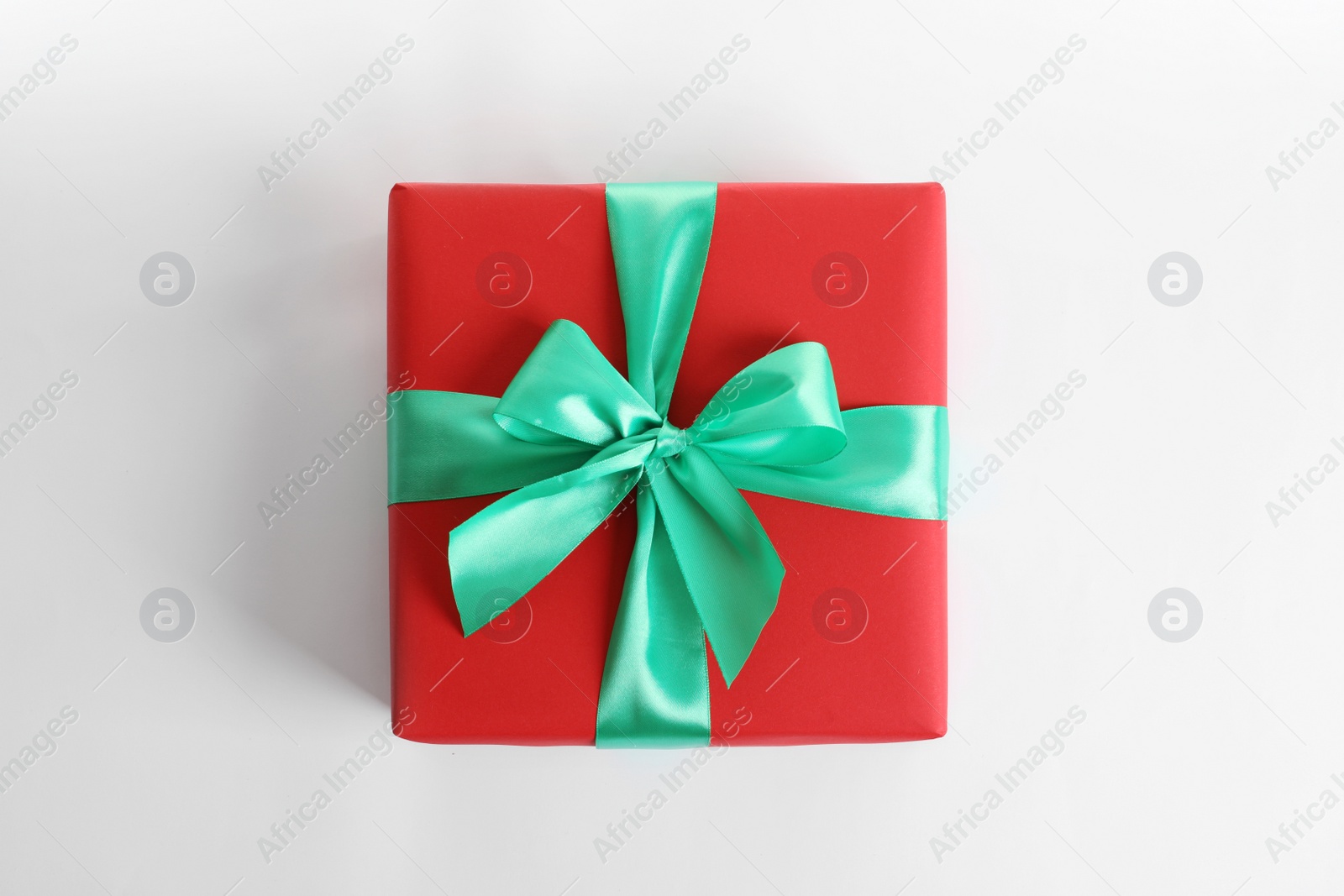 Photo of Beautifully wrapped gift box on white background, top view