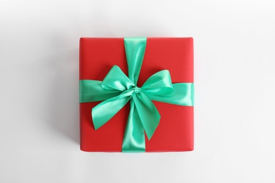 Beautifully wrapped gift box on white background, top view