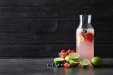 Natural lemonade with berries in bottle on table