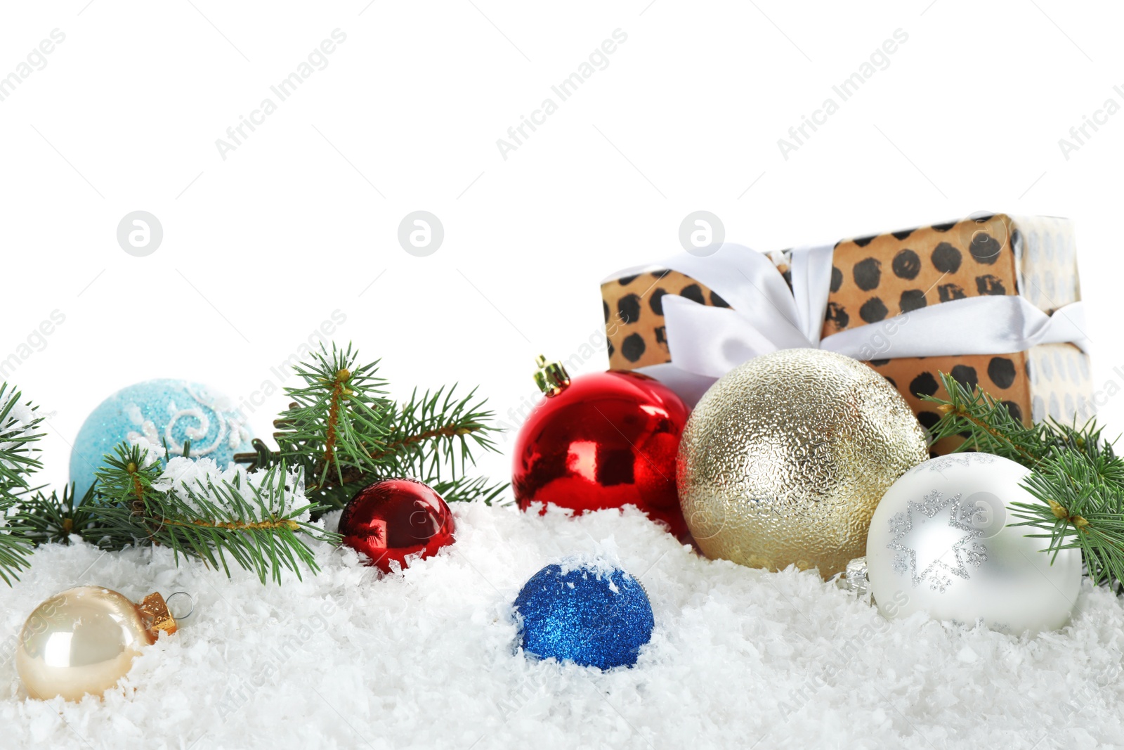 Photo of Christmas decoration with gift box on snow against white background