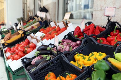 Tables with variety of fresh ripe vegetables in wholesale market