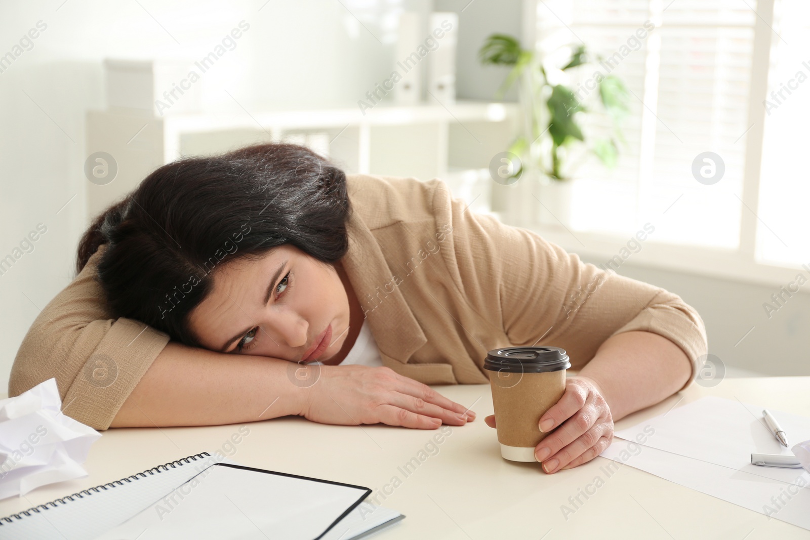 Photo of Lazy overweight worker at white desk in office