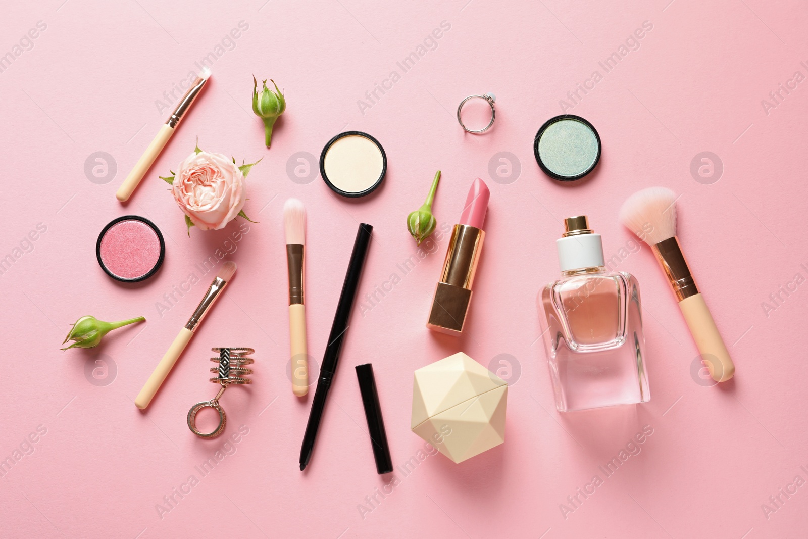 Photo of Flat lay composition with products for decorative makeup on pastel pink background