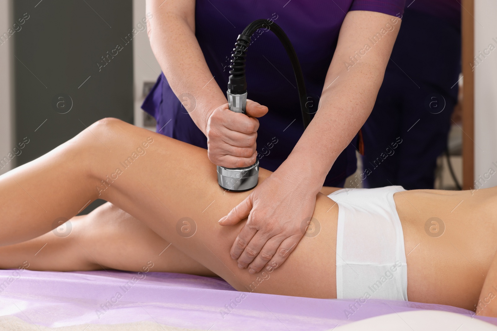 Photo of Woman undergoing radio frequency lifting procedure in beauty salon, closeup