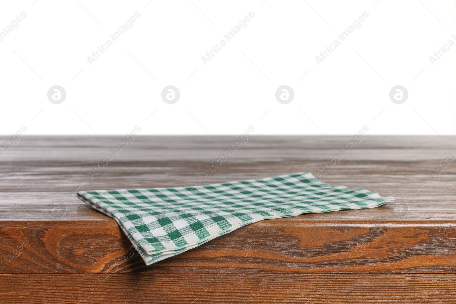 Photo of Checkered tablecloth on wooden table against white background