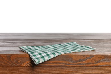 Photo of Checkered tablecloth on wooden table against white background