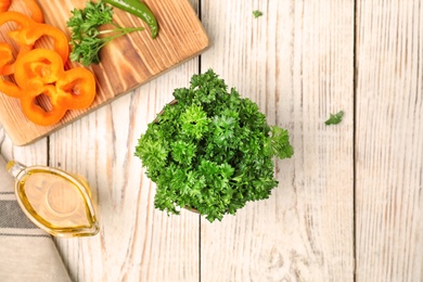 Photo of Flat lay composition with fresh green parsley on wooden background