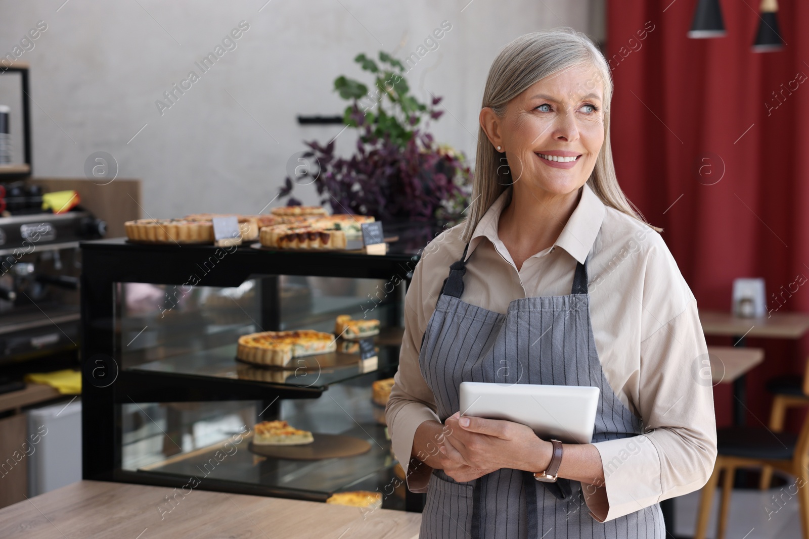 Photo of Happy business owner with tablet in her cafe, space for text