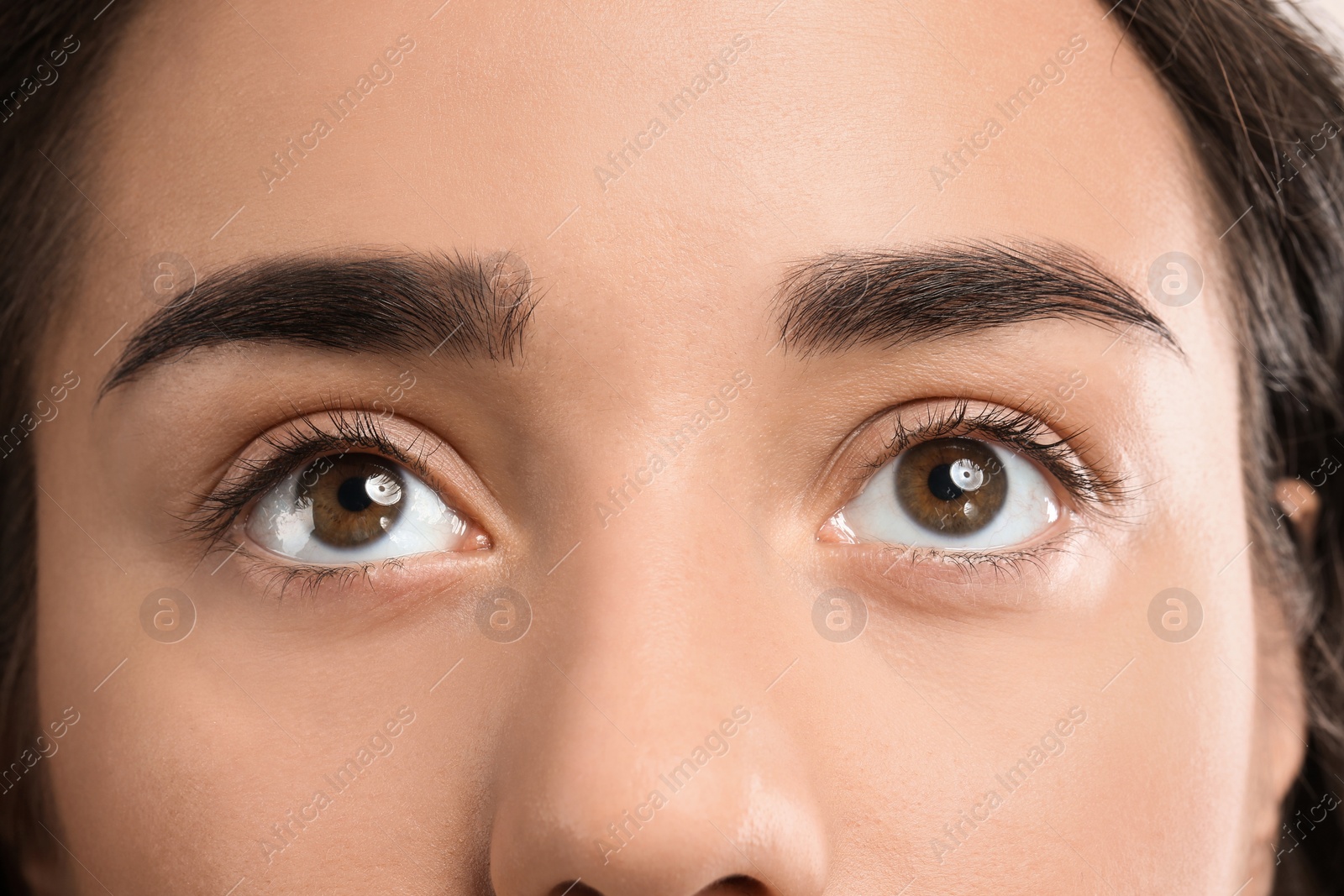 Photo of Young woman with beautiful natural eyelashes, closeup view