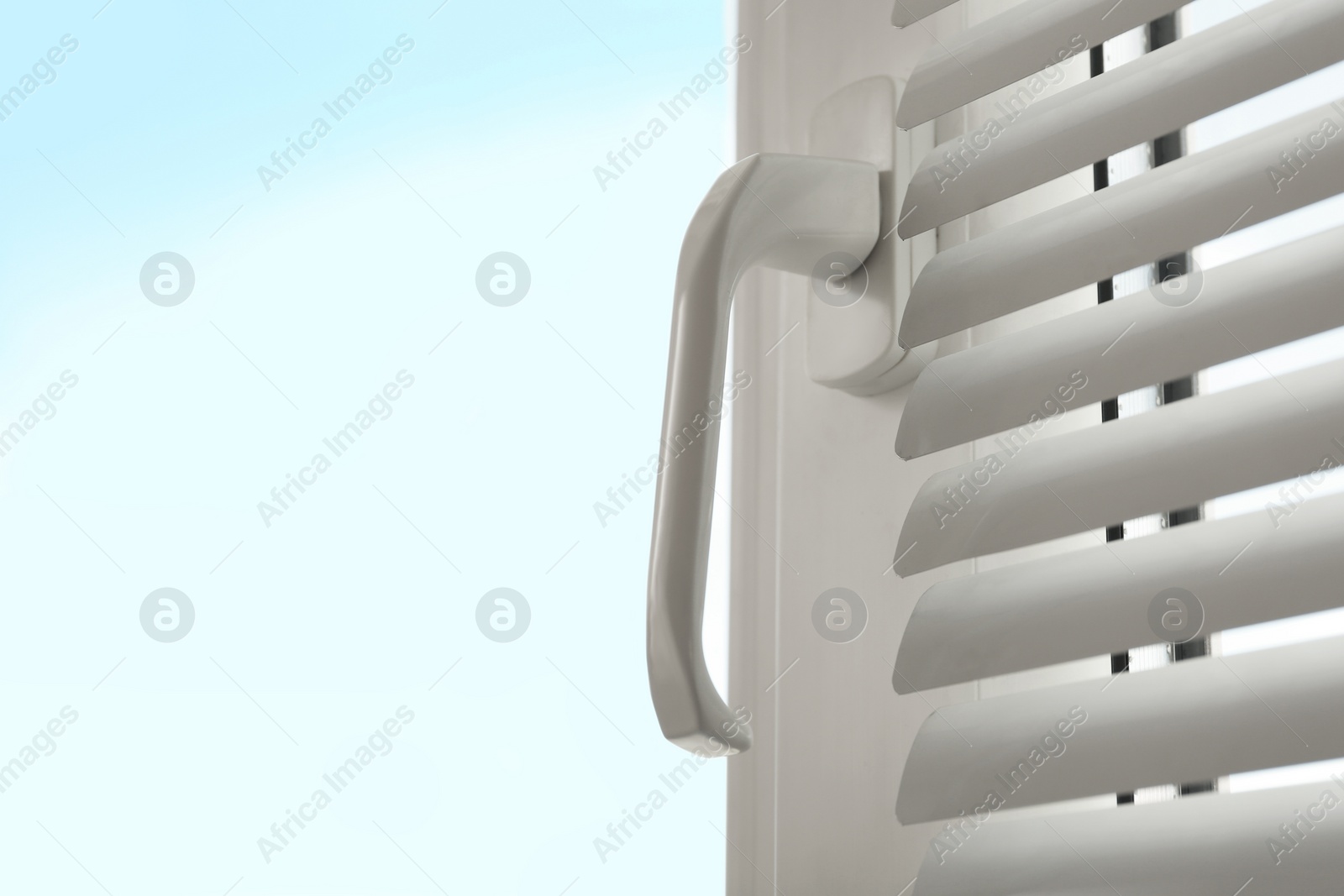 Photo of Closeup view of window with blinds. Space for text