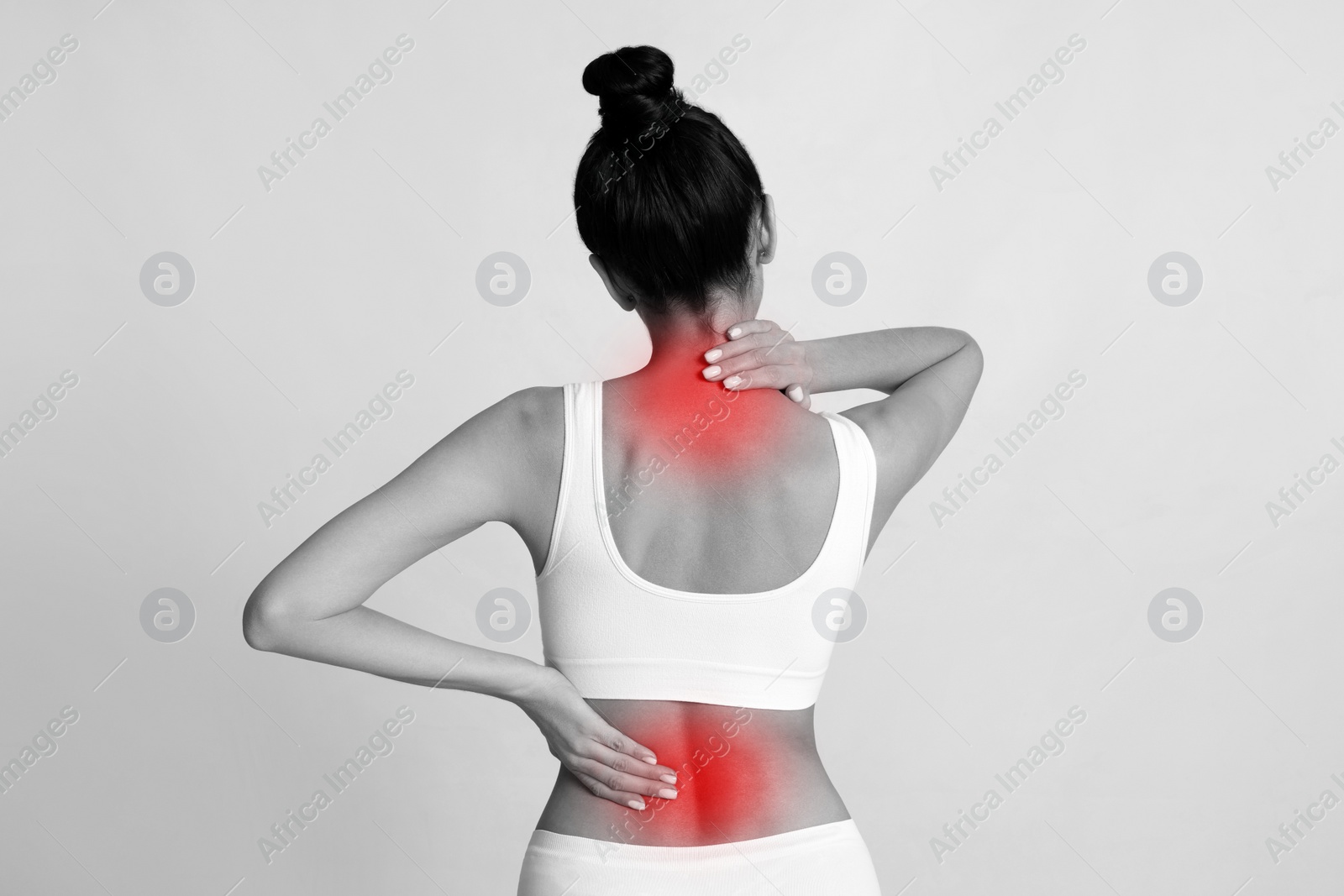 Image of Woman suffering from back and neck pain on light background