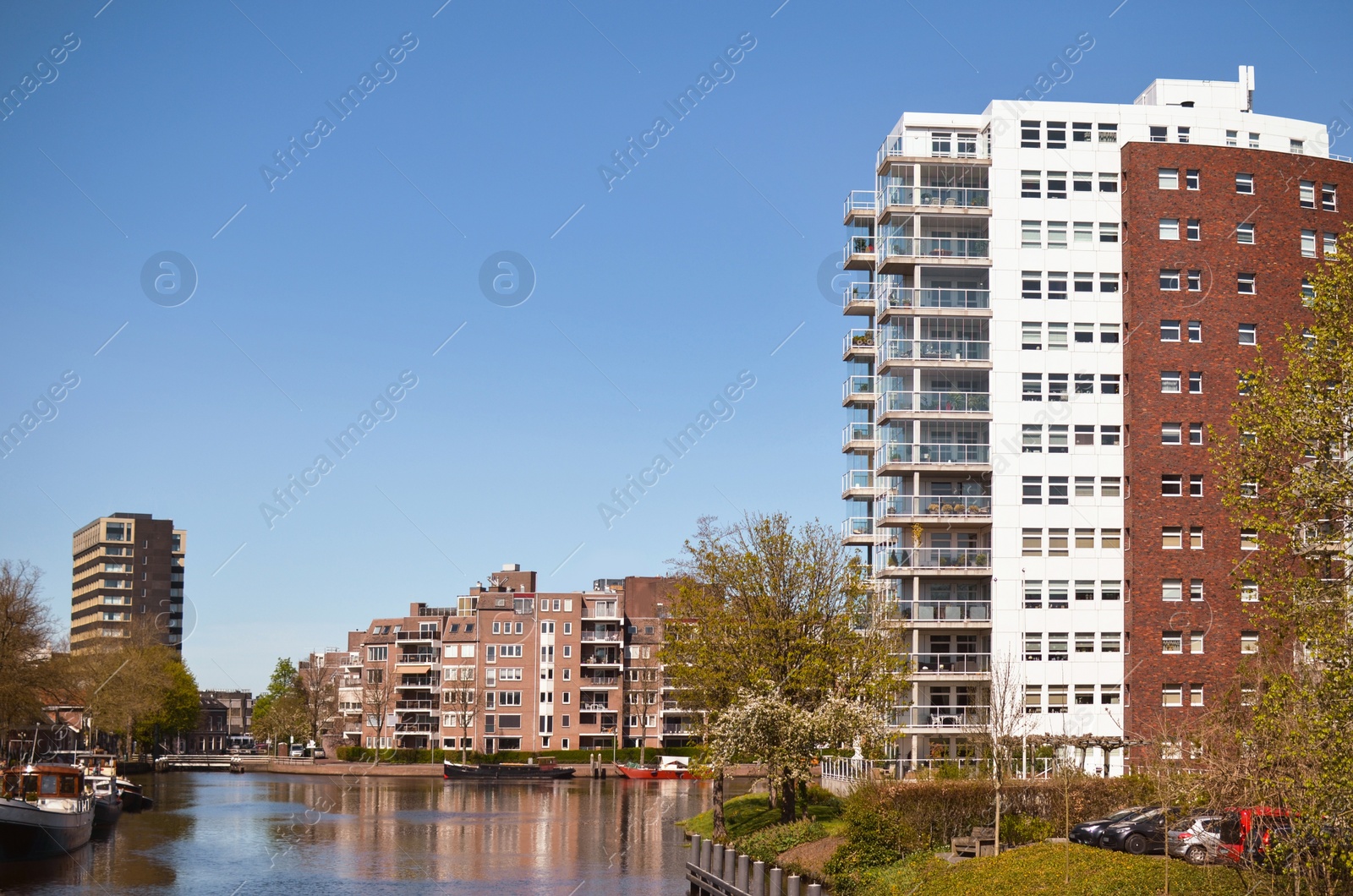 Photo of Beautiful view of cityscape with modern buildings and boats on river