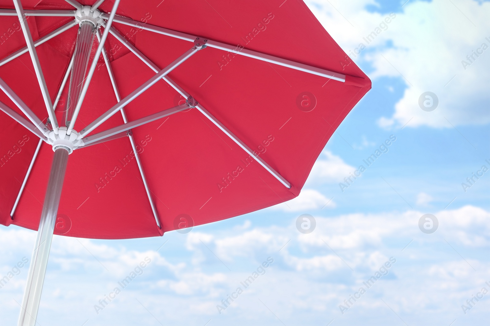 Photo of View of red umbrella and blue sky on sunny day