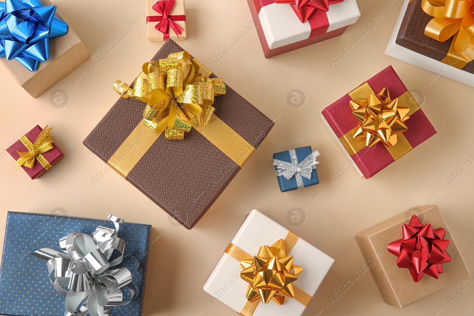 Photo of Flat lay composition with beautiful gift boxes on beige background