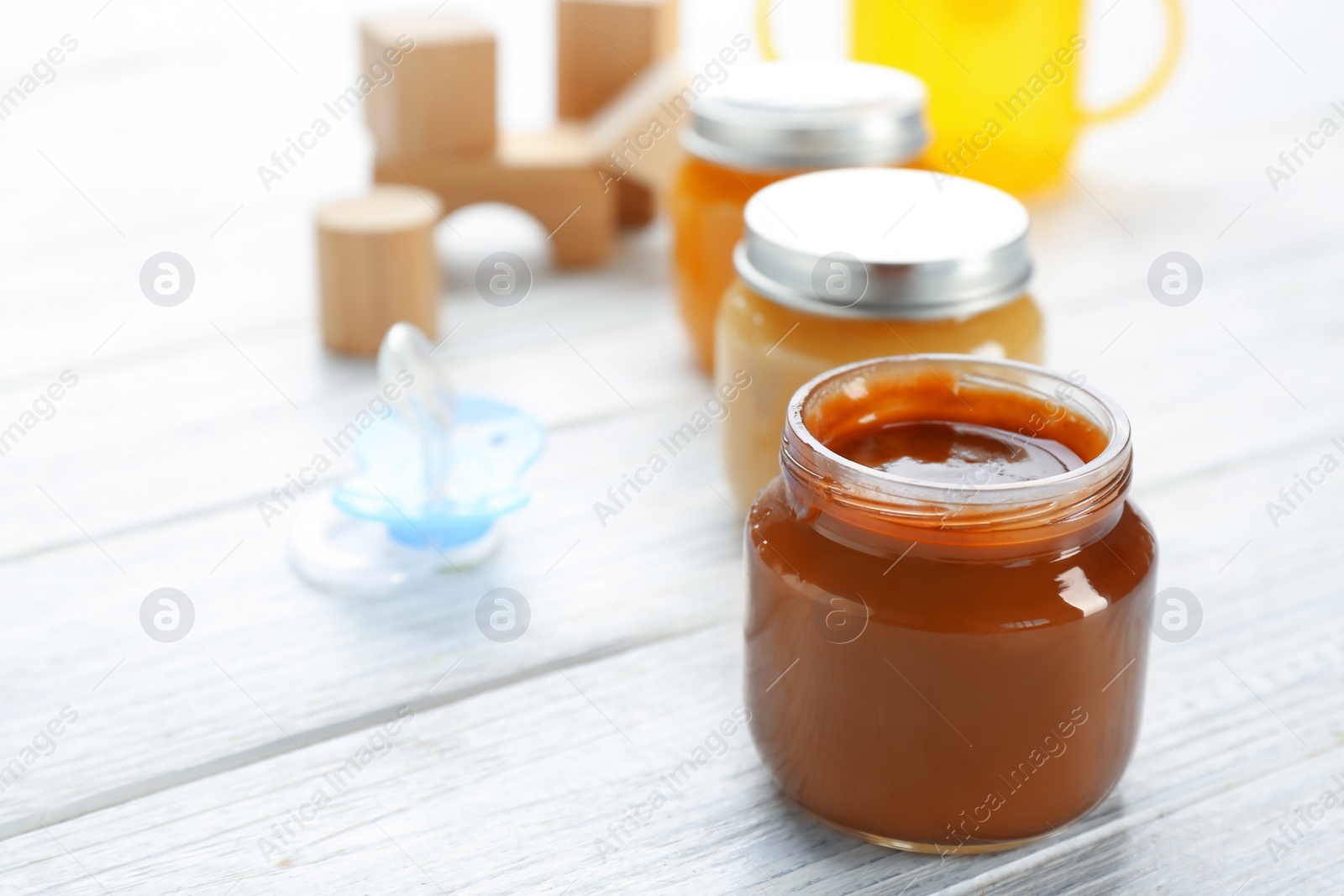 Photo of Jars with tasty baby food on table