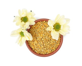 Photo of Fresh bee pollen granules in bowl and flowers isolated on white, top view