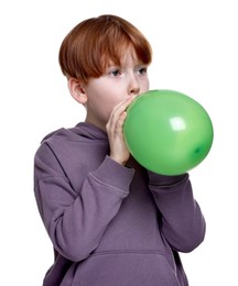 Boy inflating green balloon on white background