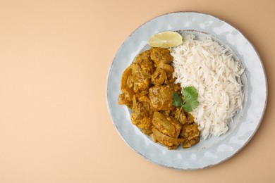 Photo of Delicious chicken curry with rice on beige background, top view. Space for text